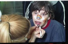 Open House 1998; child getting rainbow and clouds drawn on their face [photograph 3 of 3]