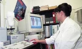 Woman viewing cast of residual limb and related detailed images on computer screen [1 of 3 photog...