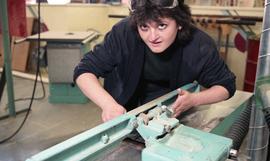 BCIT Women in Trades; carpentry, woman using bench tool (sander?) [3 of 5 photographs]