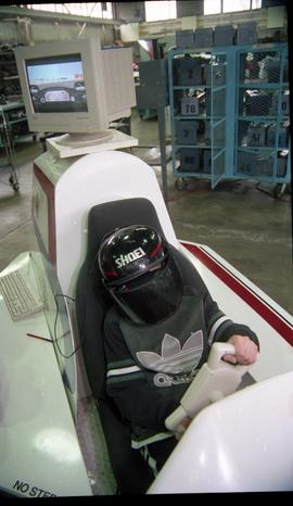Open House 1998; boy turning wheel on VR Chevrolet racing car