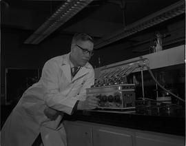 Food Processing Technology, 1966; man in a lab coat using food processing equipment [1 of 2]