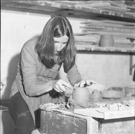 BC Vocational School Fine Arts ; a student sculpting something made of clay