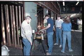 Open House 1986; student tries industrial piping clamp