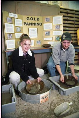 Open House 1998; two students panning for gold in front of display