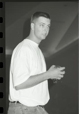 Communications Relations Opening Day 1991; man holding a BCIT travel mug vertical shot