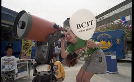 Open house 1992; child squatting and using Schmidt–Cassegrain telescope [photograph 2 of 2]
