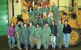 BCIT women in trades; heavy duty, students in uniforms standing in front of a bulldozer [3 of 9 p...