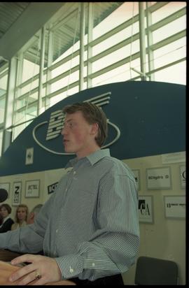 Open House 1998; man stands behind podium on Open House BCIT stage