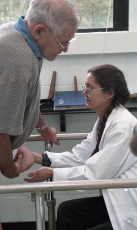 Woman in lab coat examining residual limb