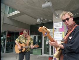 Open House 1998; two men playing guitar in front of SE2 entrance [photograph 2 of 2]