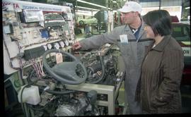 Open House 1998; man pointing at a gauge on the Toyota technical education program display in fro...