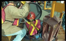 Open House 1998; woman in safety gear and line is lowered into confined space
