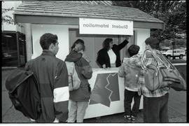 Communications Relations Opening Day 1991; woman directing students in student information kiosk ...