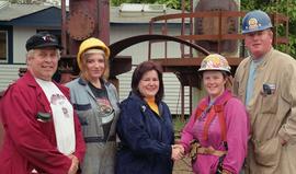 Steel trades; Anne St. Eloi shaking hands with a woman in a hard hat and safety gear beside anoth...