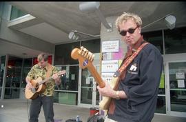 Open House 1998; two men playing guitar in front of SE2 entrance [photograph 1 of 2]