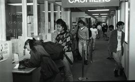 Communications Relations Opening Day 1991;  student at camera while waiting in cashier line [phot...