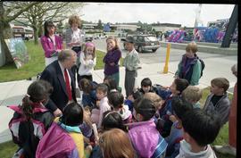 Open house 1992; man on knees speaking to school children [photograph 5 of 5]