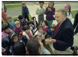 Open house 1992; man on knees speaking to school children [photograph 1 of 5]