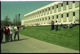 Open House 1998; students passing by while other students sit on grass hill