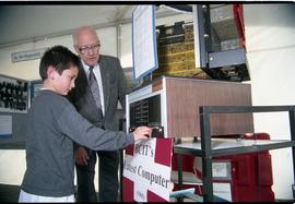 Open House 1998; boy touches BCIT's latest computer (1965) display as older man looks on [photogr...
