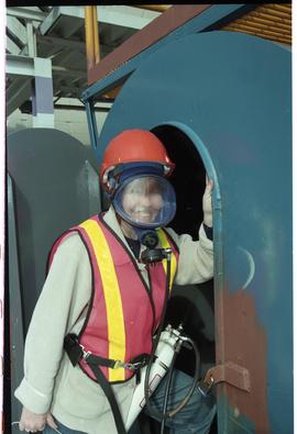 Open House 1998; close up of person in safety vest and gas mask