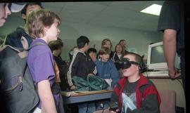 Open House 1998; crowd of students watching boy on VR headset