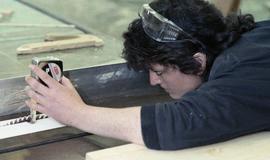 BCIT Women in Trades; carpentry, woman with measuring tape [1 of 2 photographs]