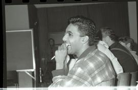 Communications Relations Opening Day 1991; student in lecture seat laughing and holding a pen