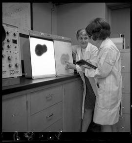 B.C. Vocational School image of an instructor and student viewing an image on electronic equipmen...