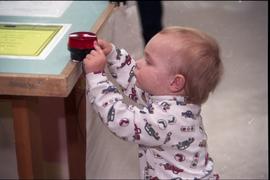 Open House 1998; toddler pressing red alarm light