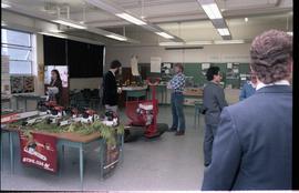 Open House 1986; people viewing chainsaw display [photograph 1 of 2]