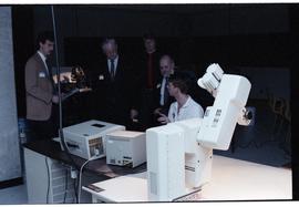 Open House 1986; man explaining medical equipment to guests