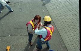 Open House 1998; man in safety gear strapping woman in into harness