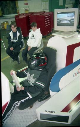 Open House 1998; boys watching  boy on VR Chevrolet racing car