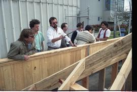 Open house 1992; man explaining to class in front of wooden construction