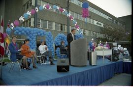 Open House 1992; man making speech while others applaud on stage