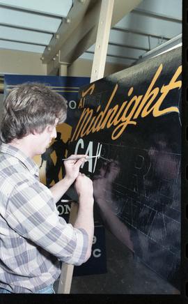 Open House 1986; man painting sign [1 of 2 photographs]