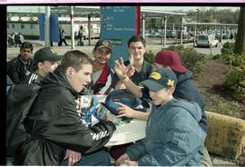 Open House 1998; candid photo of male students having lunch at outside table
