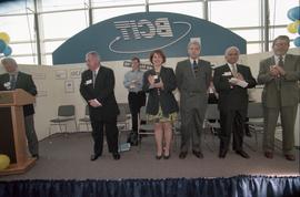 Open House 1998; woman and men on Open House BCIT stage with speaker behind podium on the far lef...