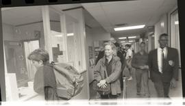 Communications Relations Opening Day 1991; student in front of registration desk as others walk p...