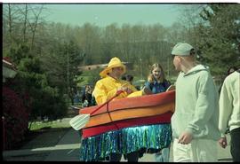 Open House 1998; man in raincoat and boat costume interacting with passerby [photograph 1 of 2]