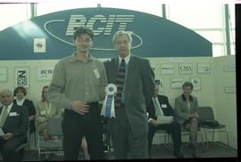 Open House 1998; student poses with older man in suit with first prize ribbon [photograph 1 of 2]
