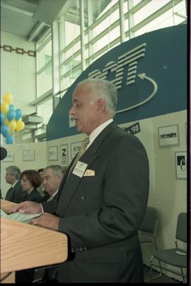 Open House 1998; older man recites speech behind podium on Open House BCIT stage [photograph 2 of 2]