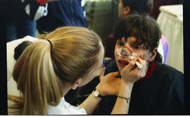 Open House 1998; child getting rainbow and clouds drawn on their face [photograph 1 of 3]