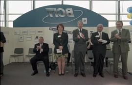 Open House 1998; woman standing with men on BCIT stage [photograph 2 of 2]