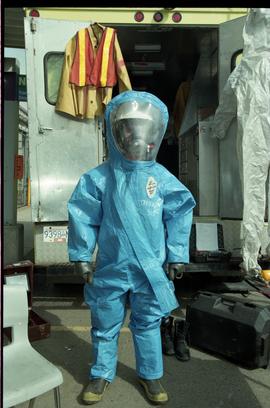 Open House 1998; person standing in training suit  made of tarp with gas mask underneath [photogr...
