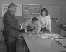 B.C. Vocational School; BTSD Basic Training program instructor with two students and a microscope...