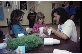 Open house 1992; two girls and woman making crafts with fake grass and cups [photograph 2 of 2]