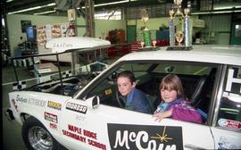 Open House 1998;  long view of two children sitting in driver's seat of McCain's racing car with ...