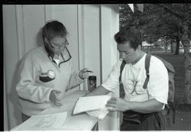 Communications Relations Opening Day 1991;  student pointing at papers to woman in student inform...